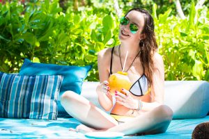 Ella with fresh coconut at Four Seasons resort on Mahe island, Seychelles