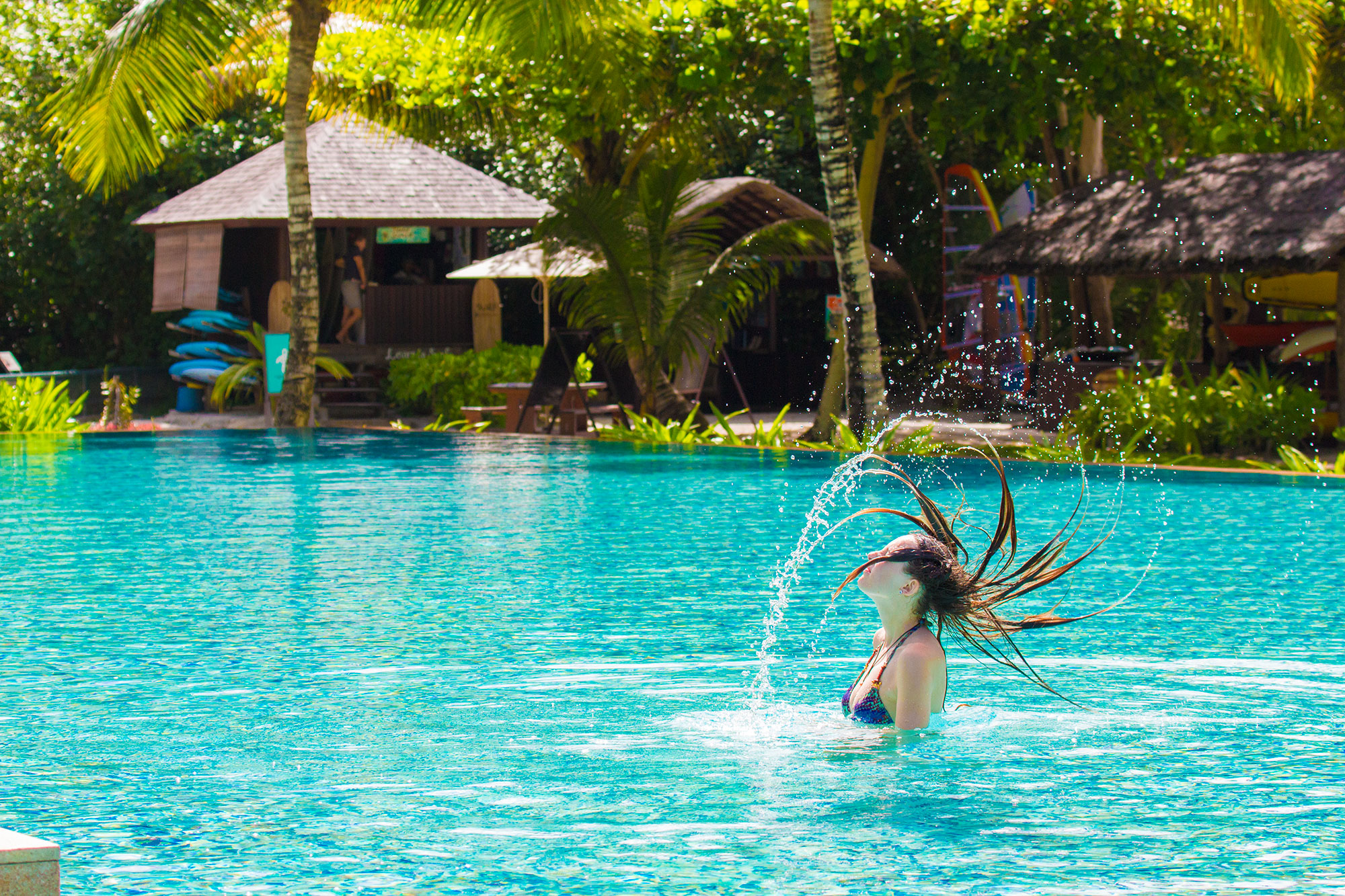 Ella in swimming pool at Four Seasons resort on Mahe island, Seychelles
