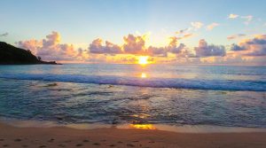 Drone view of Takamaka beach, sunset and ocean on Mahe island, Seychelles