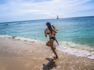 Ella on the beach by the ocean in Barbados