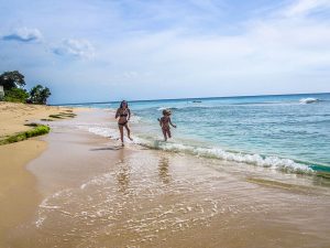 Ella on the beach by the ocean in Barbados