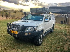Toyota Hilux 4x4 with roof-top tent in rest camp in Namibia