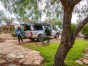 Ella with Toyota Hilux 4x4 with roof-top tent on campsite near Windhoek in Namibia