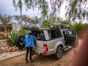 Ella with Toyota Hilux 4x4 with roof-top tent on campsite near Windhoek in Namibia