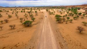 Drone view of Toyota Hilux self-drive through the desert in Damaraland, Namibia, Africa