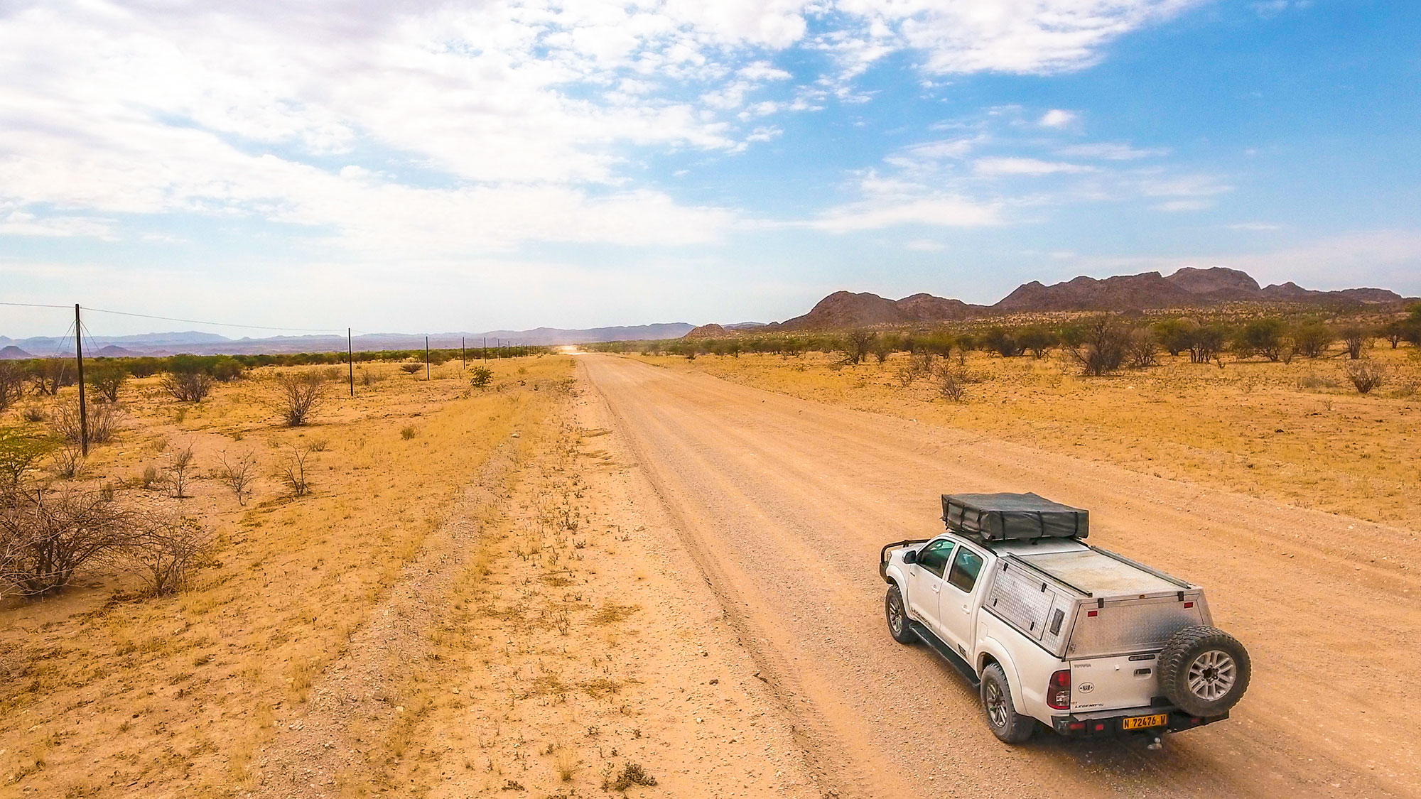 Drone view of Toyota Hilux self-drive through the desert in Damaraland, Namibia, Africa