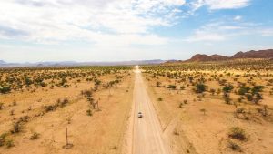 Drone view of Toyota Hilux self-drive through the desert in Damaraland, Namibia, Africa