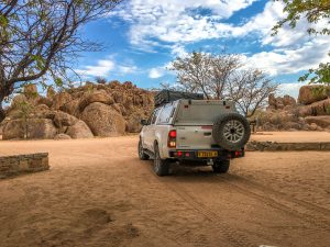 Toyota Hilux 4x4 with roof-top tent in Madisa desert campsite in Damaraland in Namibia, Africa