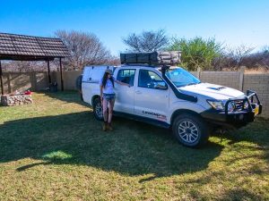 Ella with Toyota Hilux 4x4 with roof-top tent at Ombo Rest Camp in Namibia, Africa