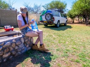 Ella with Toyota Hilux 4x4 with roof-top tent at Ombo Rest Camp in Namibia, Africa