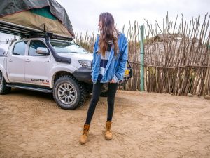 Ella and Toyota Hilux 4x4 with roof-top tent at campsite in Swakopund, Namibia, Africa