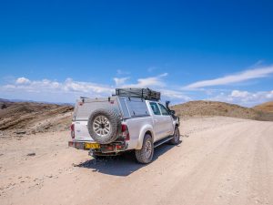 Toyota Hilux 4x4 with roof-top tent at Kuiseb Pass canyon in Namib Desert, Namibia, Africa