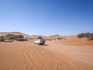 Toyota Hilux self-drive 4x4 in Sossusvlei with sand dunes, Namib Desert in Namibia, Africa