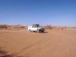 Toyota Hilux self-drive 4x4 in Sossusvlei with sand dunes, Namib Desert in Namibia, Africa
