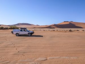 Toyota Hilux self-drive 4x4 in Sossusvlei with sand dunes, Namib Desert in Namibia, Africa