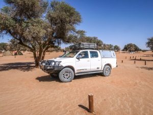 Toyota Hilux 4x4 with rooftop tent at Sesriem campsite in Sossusvlei, Namib Desert in Namibia, Africa
