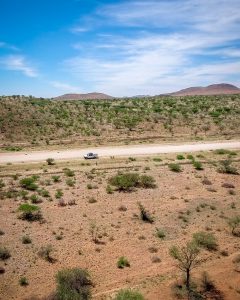 Drone view of Toyota Hilux 4x4 self-drive road-trip through Namibia, Africa