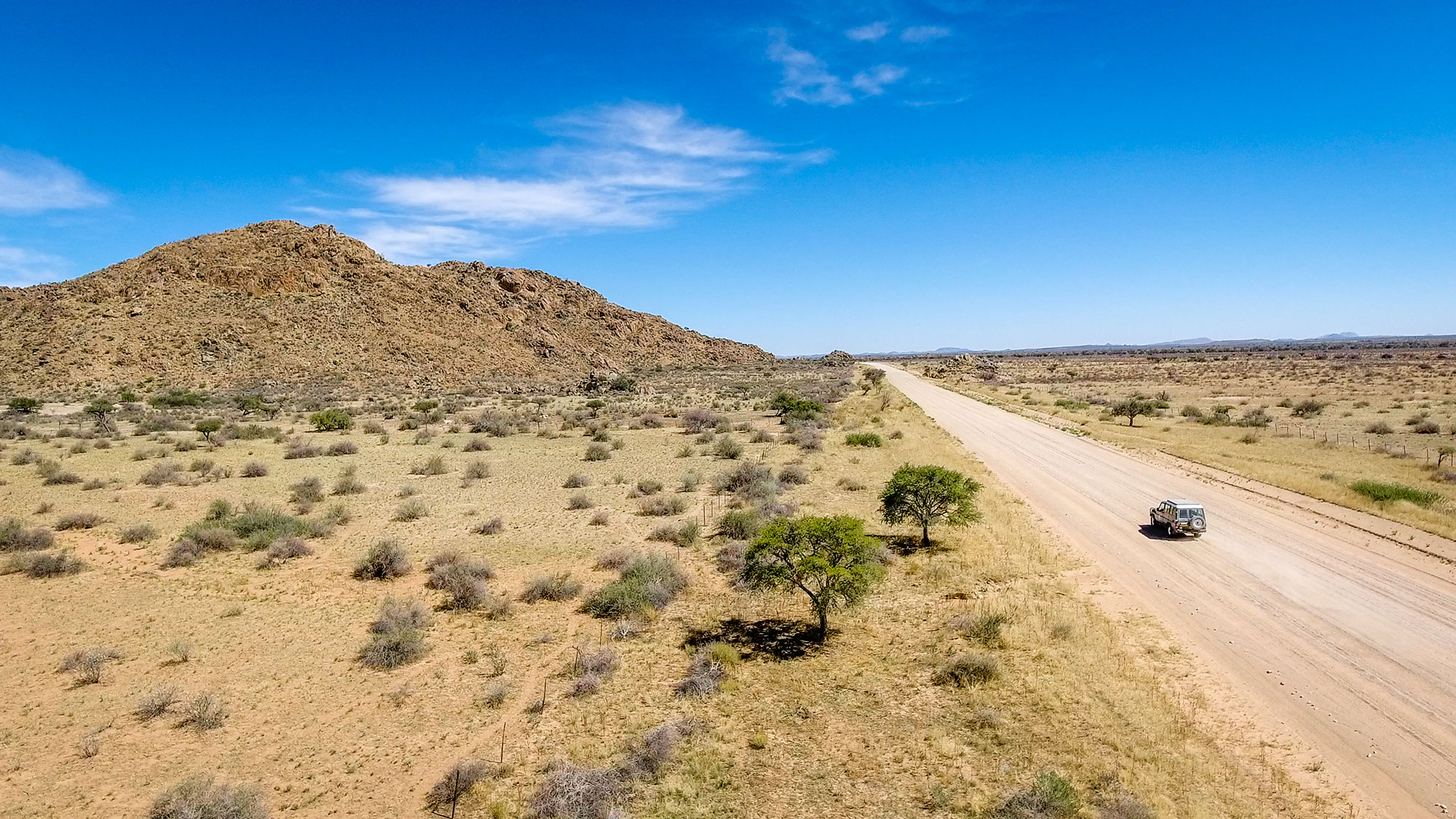 Drone view of Toyota Hilux 4x4 self-drive road-trip through Namibia, Africa