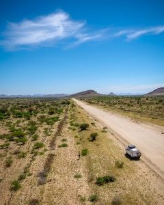 Drone view of Toyota Hilux 4x4 self-drive road-trip through Namibia, Africa