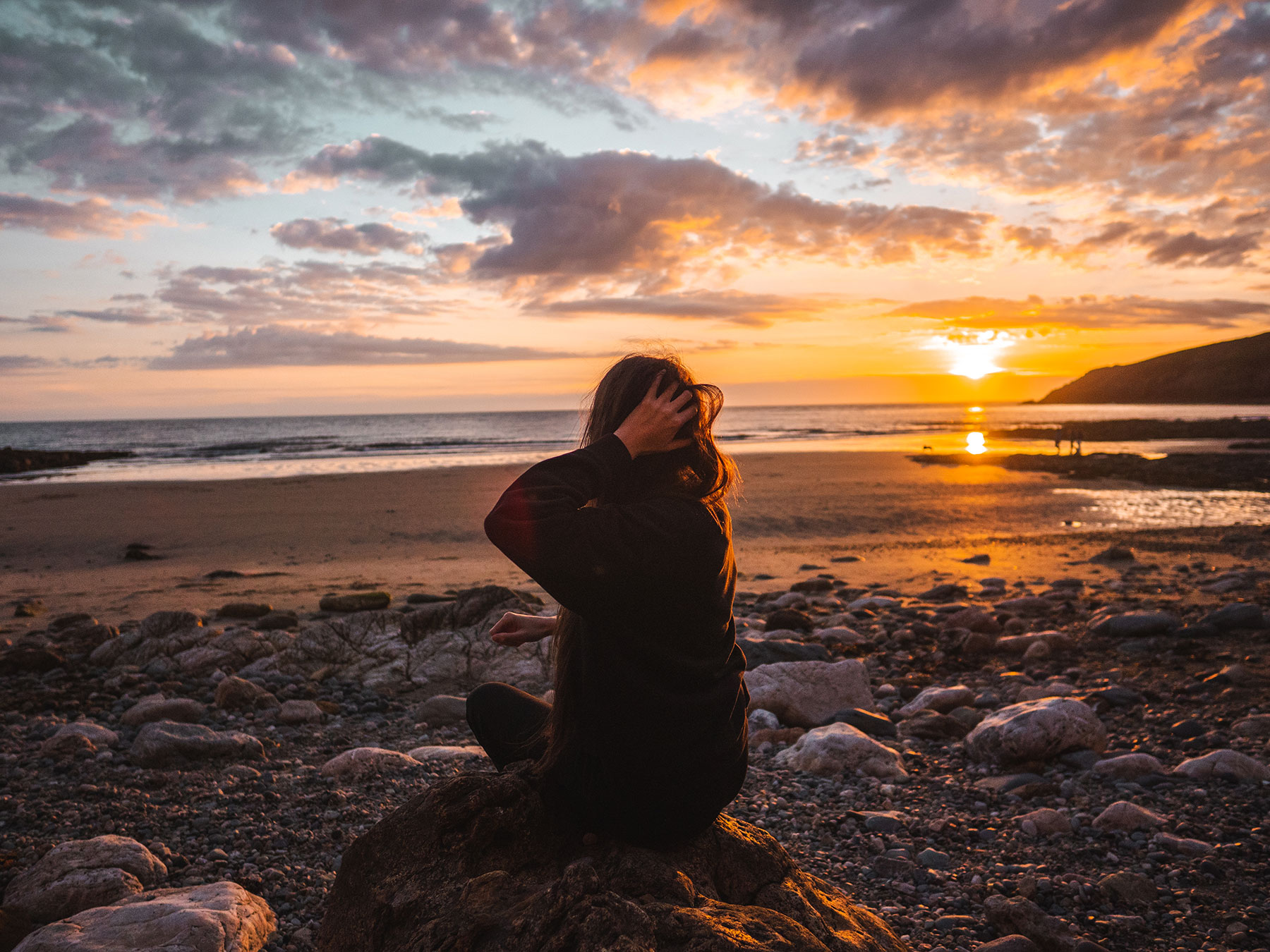 Ella McKendrick on Church Bay Beach in Anglesey, Wales at Sunset