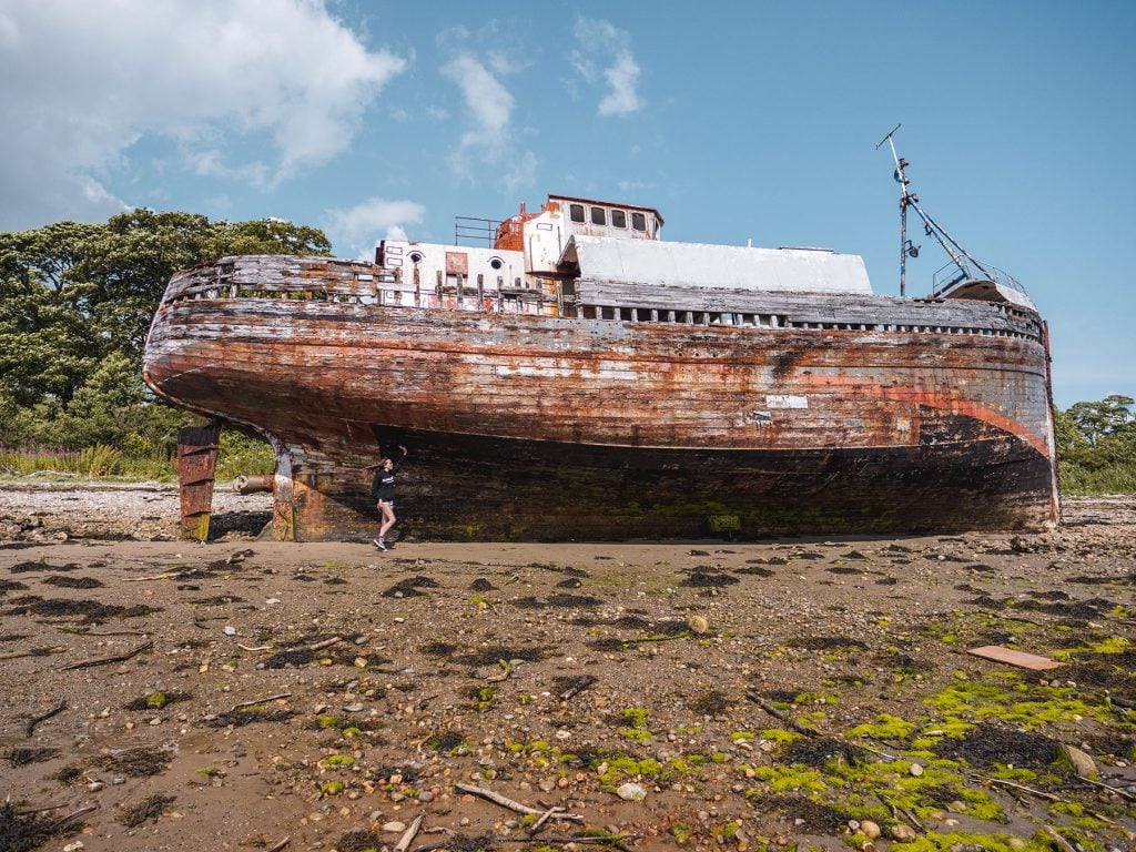 Ella McKendrick with the Corpach Shipwreck in Fort William, Scotland