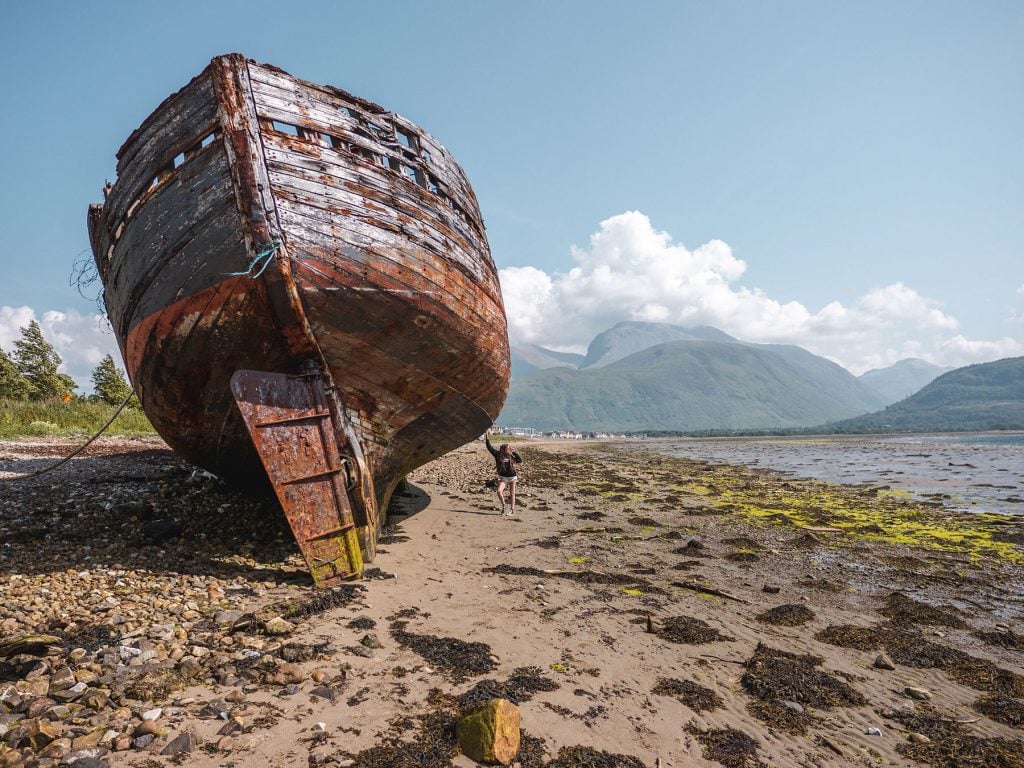 Ella McKendrick with the Corpach Shipwreck in Fort William, Scotland