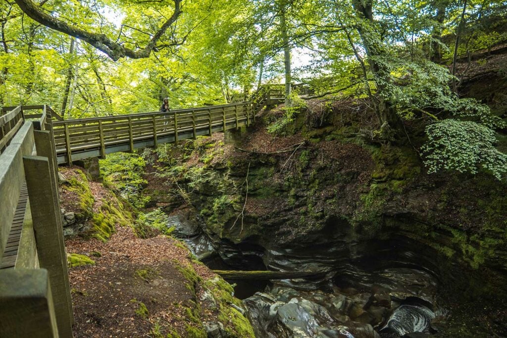 Ella McKendrick on Bridge over Upper Falls of Acharn, Loch Tay, Scotland