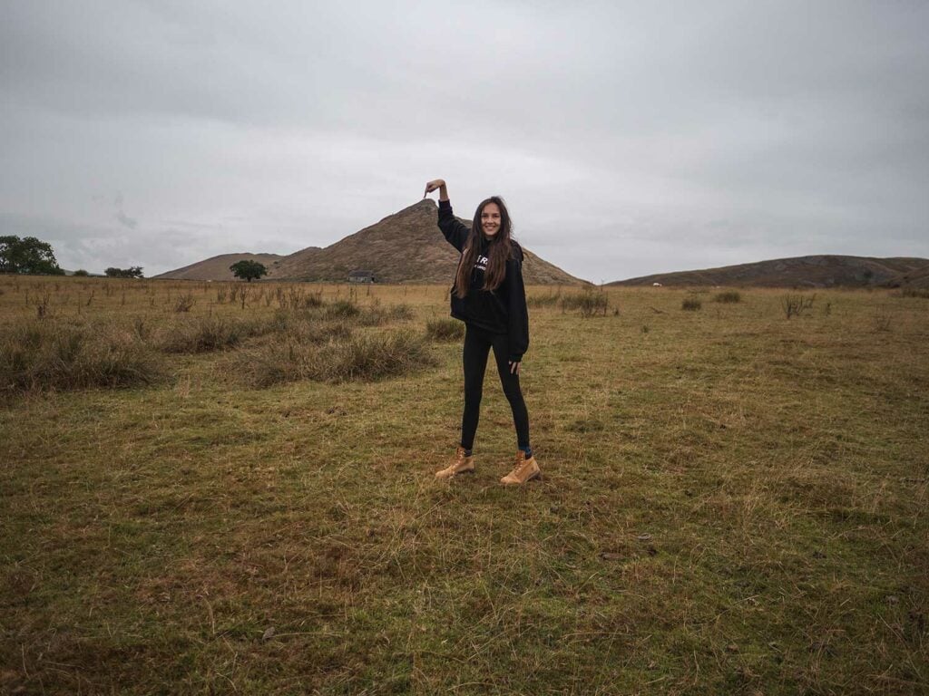 Ella pointing to the top of Thorpe Cloud