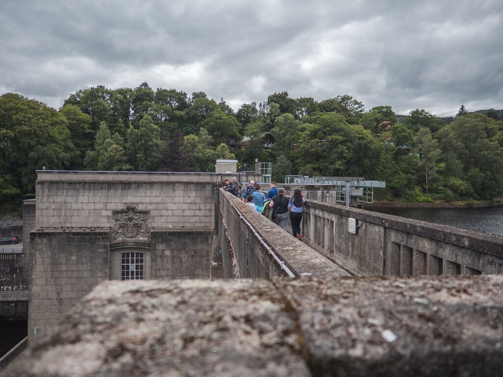 Walking at the top of Pitlochry Dam on the River Tummel in Pertshire, Scotland