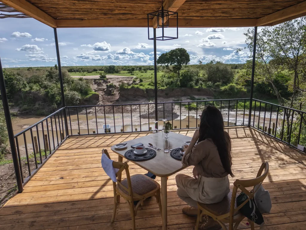 Ella Mckendrick eating lunch at a luxury lodge with views across the Kenyan Masai Mara