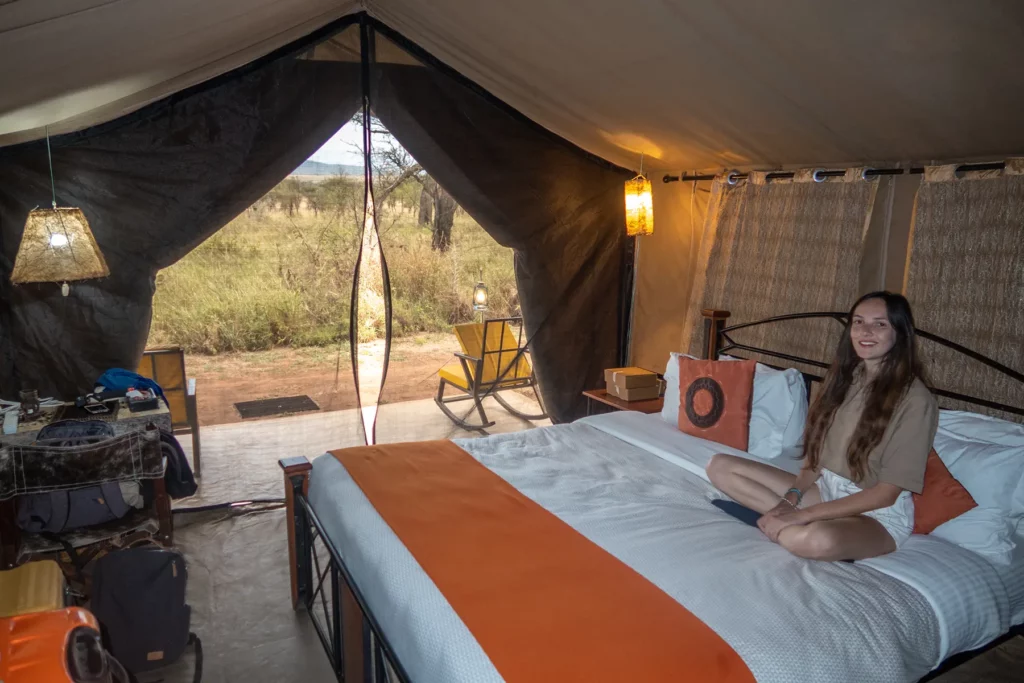 Ella Mckendrick sat on bed in Serengeti tented camp