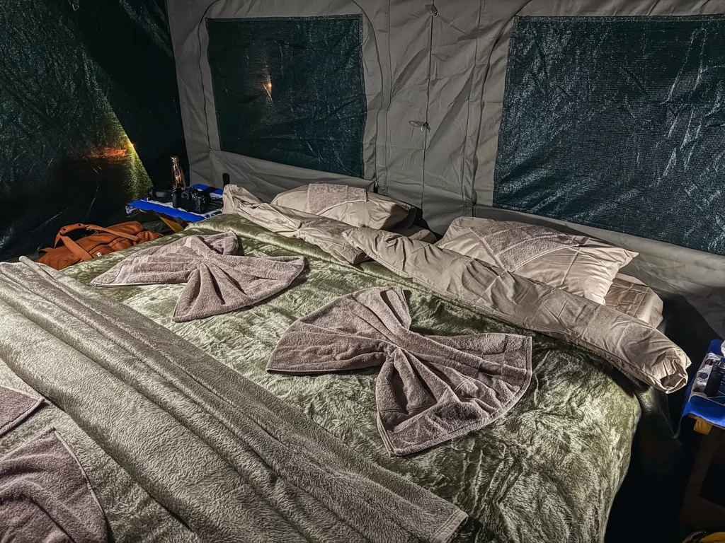 Bed inside a luxury camping safari tent in Khwai, Botswana