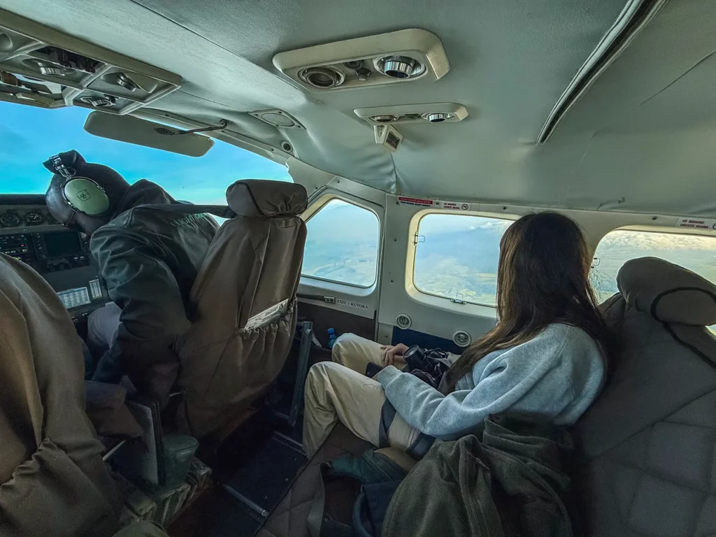 Ella McKendrick on small safari plane (Cessna Caravan) flying over the Serengeti in Tanzania