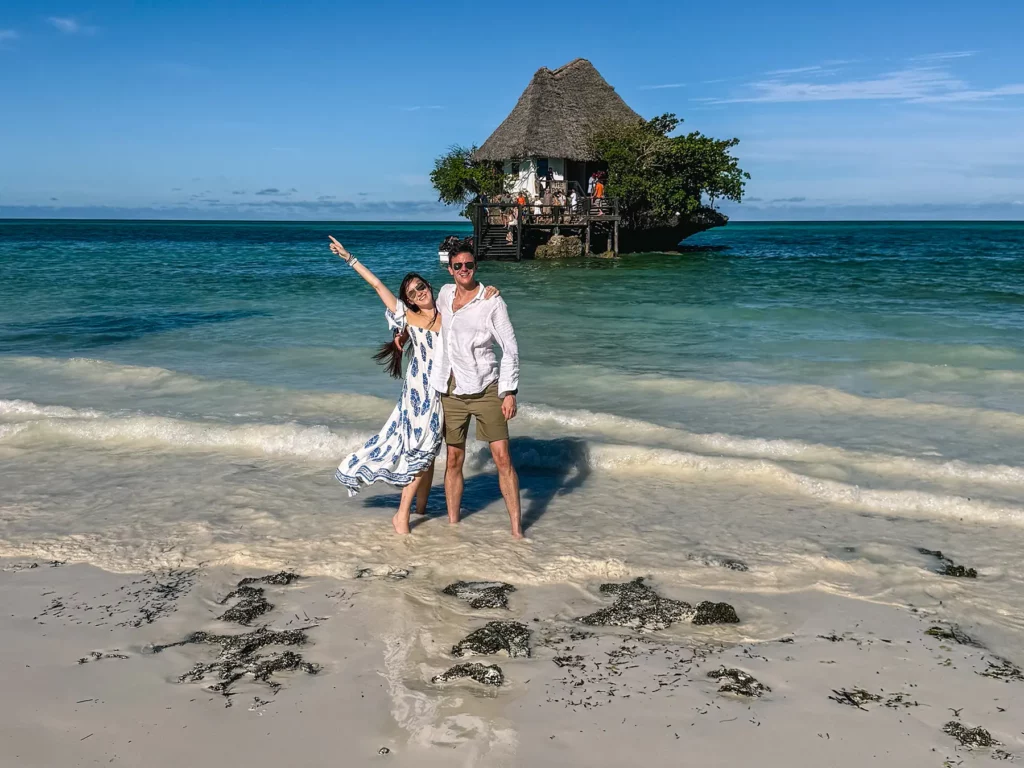 Ella McKendrick in front of the Rock Restaurant surrounded by white sandy beaches and crystal clear waters in Zanzibar, Tanzania