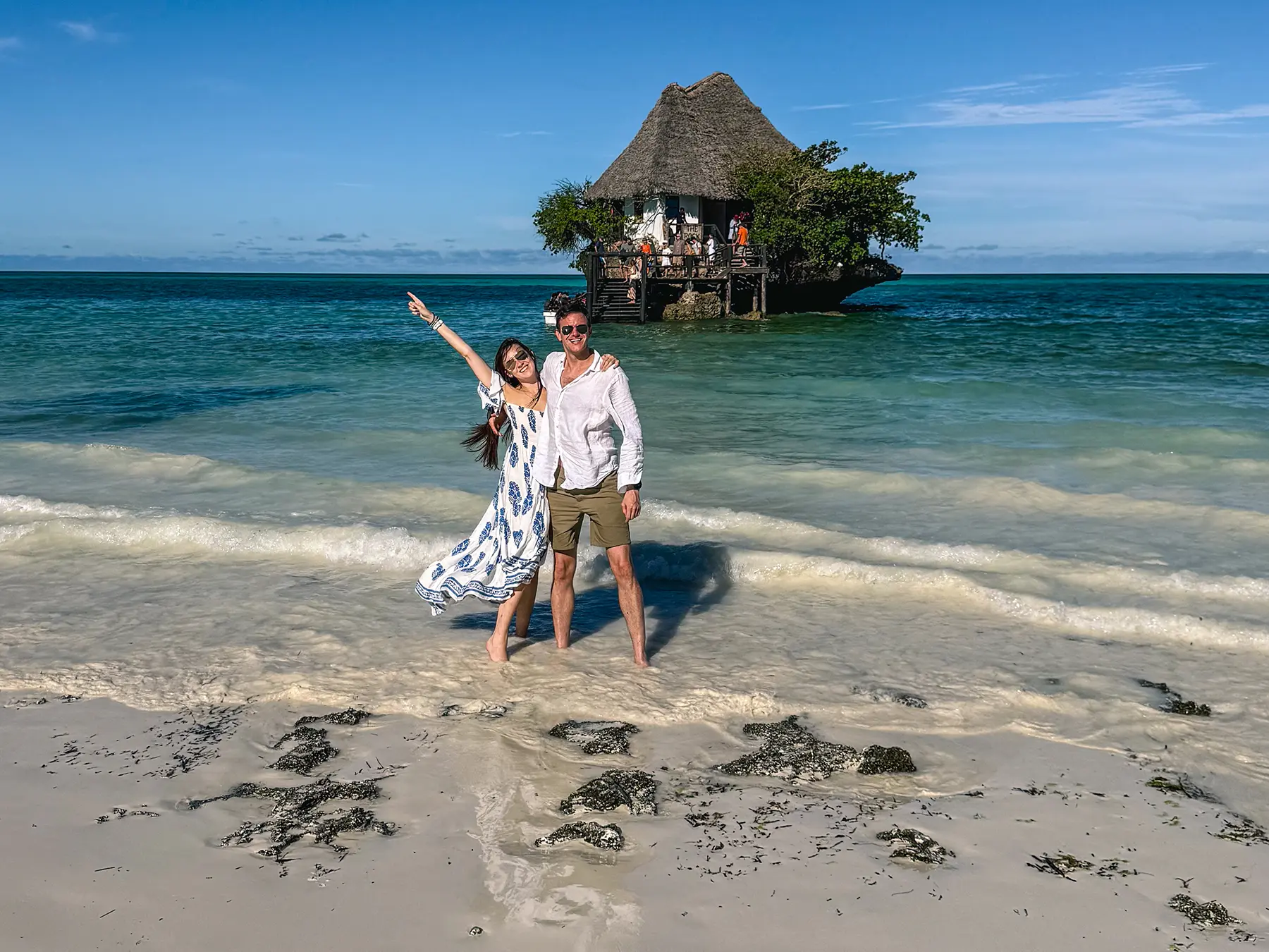 Ella McKendrick in front of the Rock Restaurant surrounded by white sandy beaches and crystal clear waters in Zanzibar, Tanzania