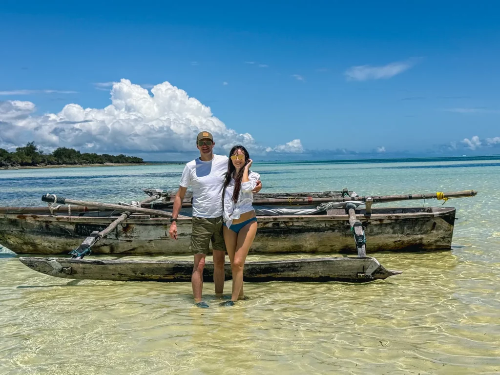 Ella McKendrick Zanzibar, Tanzania honeymoon. Posing in front of fishing boat near beach.