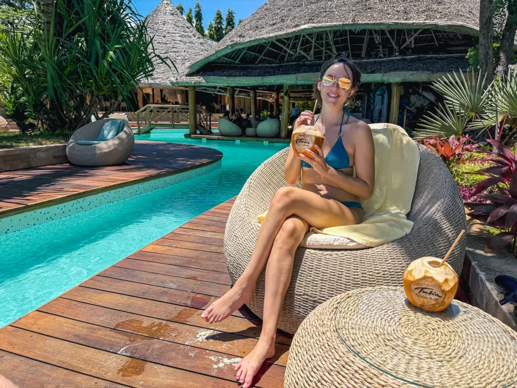 Ella McKendrick drinking a fresh coconut in Zanzibar. Tanzania at a luxury hotel accommodation