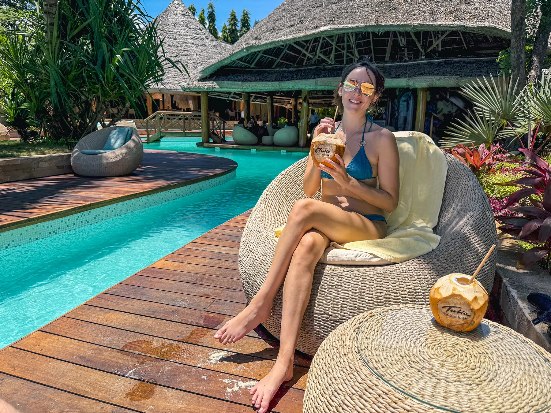 Ella McKendrick drinking a fresh coconut in Zanzibar. Tanzania at a luxury hotel accommodation