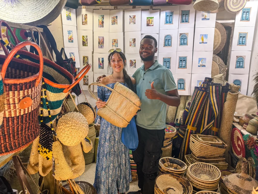 Ella McKendrick buying a handmade bag in Stone Town, Zanzibar