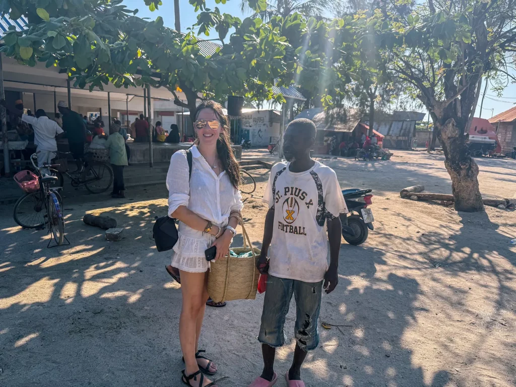 Ella McKendrick with local souvenir maker on Nungwi Beach, Zanzibar