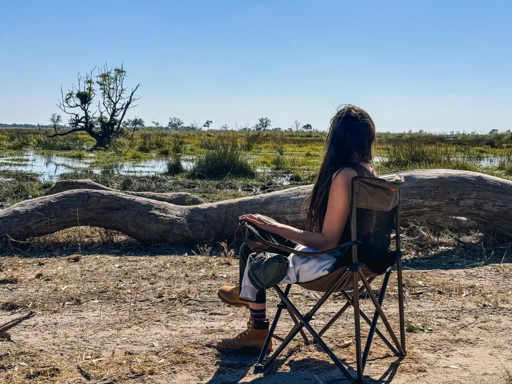 Ella McKendrick having lunch whilst watching elephants in Moremi Game Reserve, Okavango Delta, Botswana