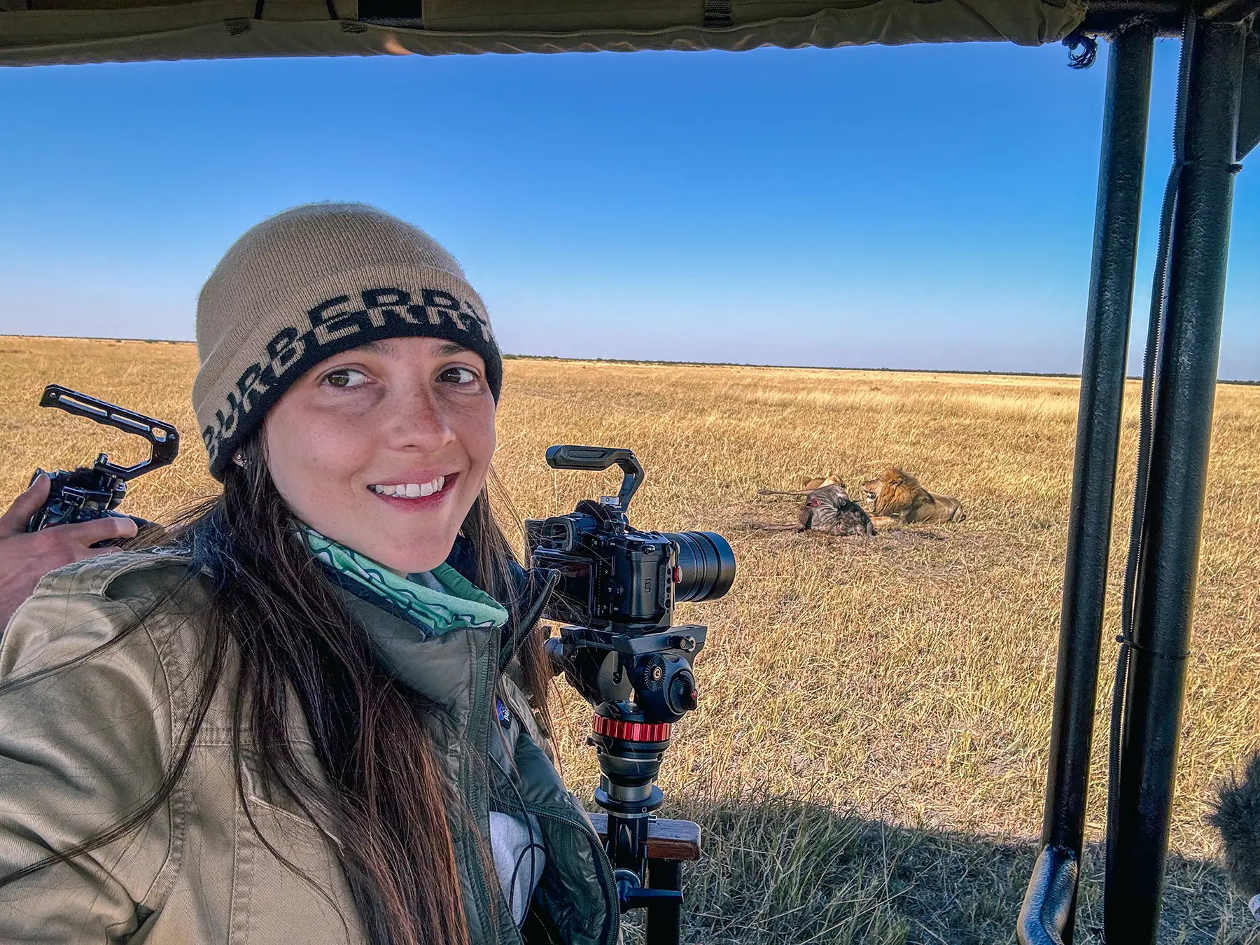 Ella Mckendrick photographing a lion on a kill in Savuti, Chobe National Park, Botswana