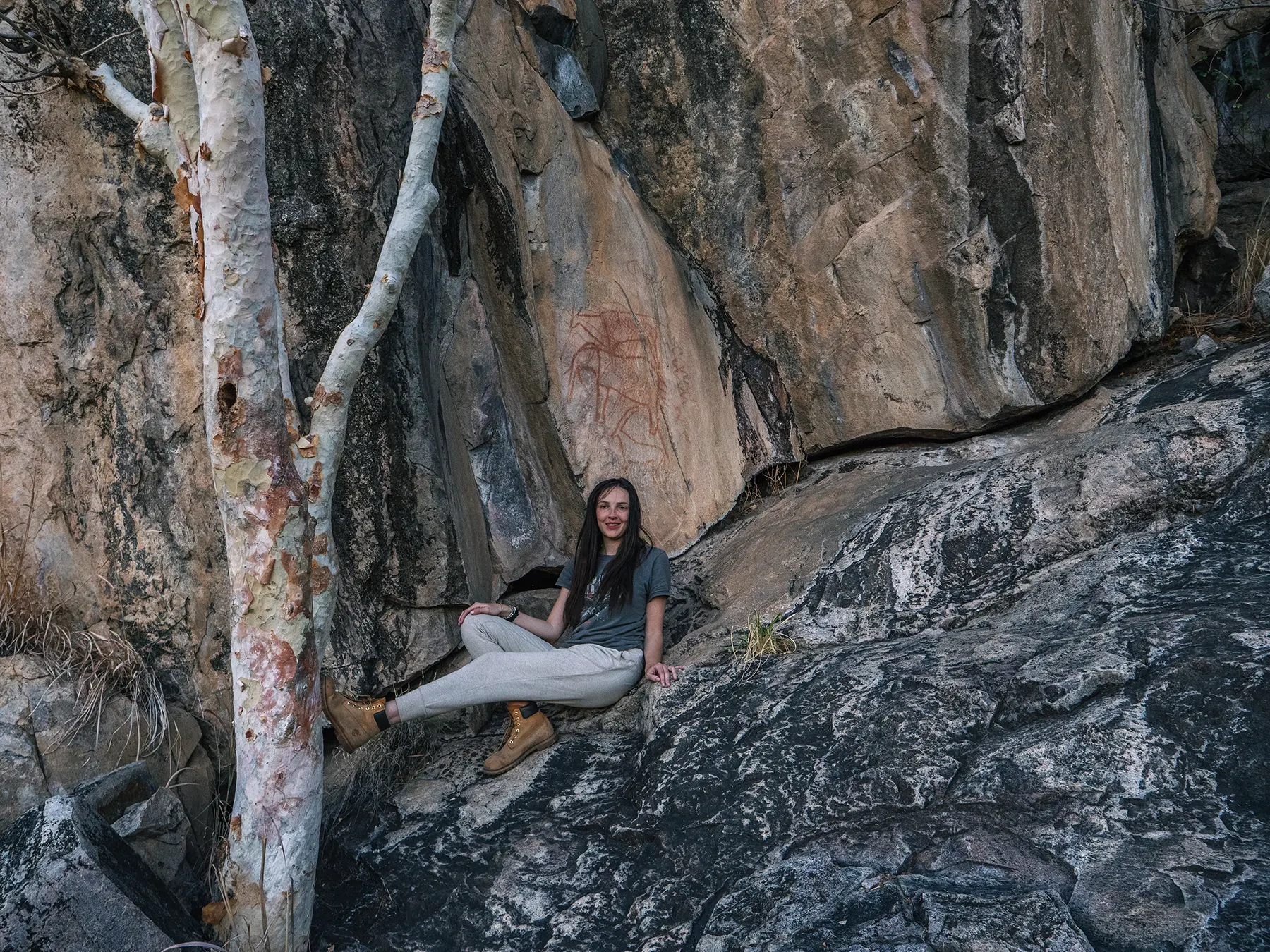 Ella Mckendrick looking at ancient paintings in Savuti, Chobe National Park, Botswana