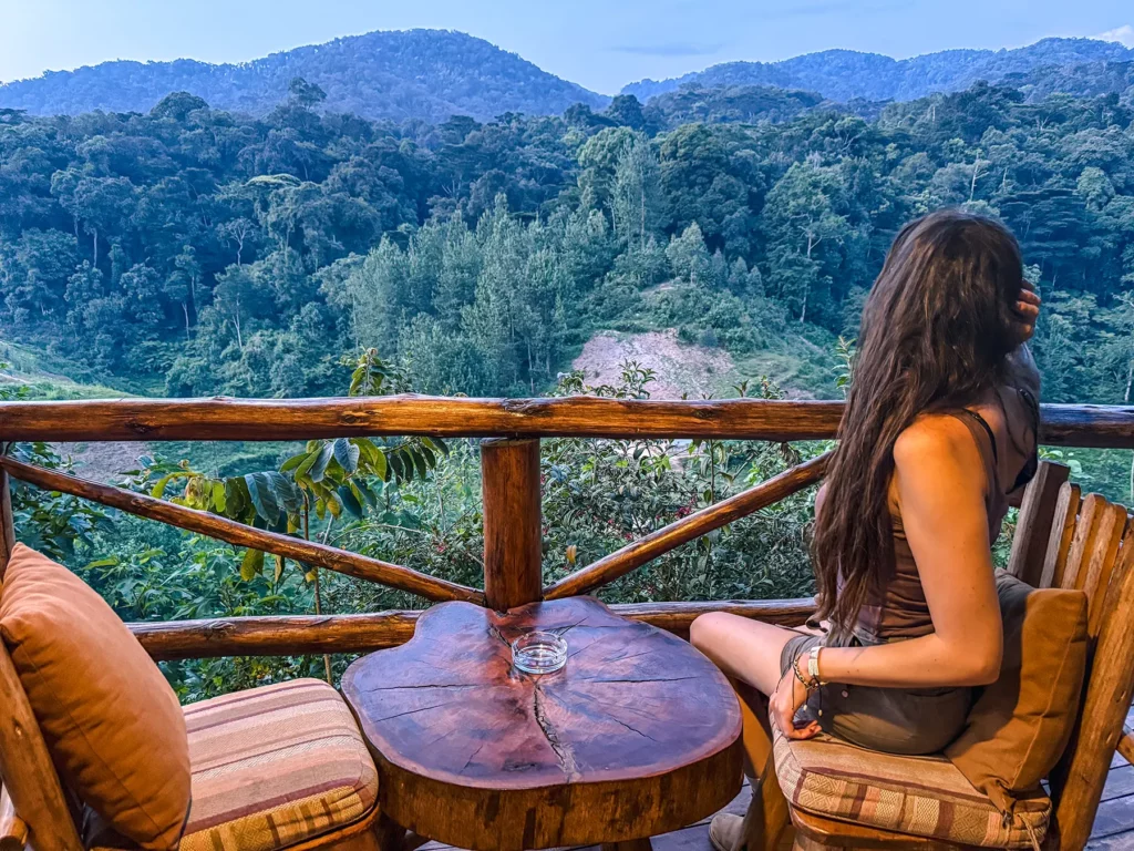 Ella McKendrick at Rushaga Gorilla Lodge with views across Bwindi Impenetrable Forest, Uganda