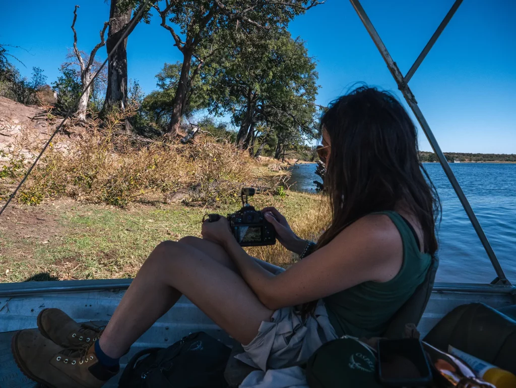 Ella Mckendrick photographing a crocodile on a Chobe Riverfront safari, Botswana