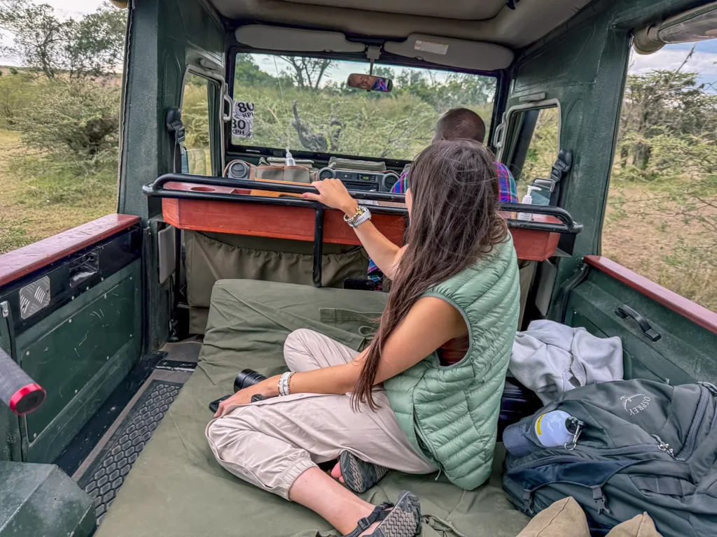 Ella McKendrick in photography-ready open-sided Land Cruiser in Kenya