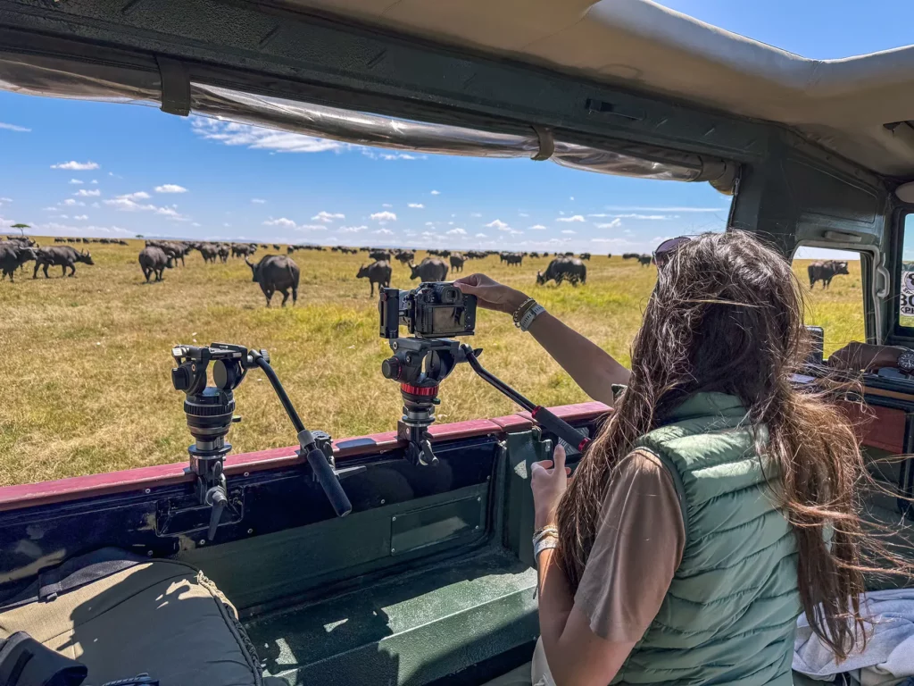 Ella McKendrick photographing a herd of buffalo in the Maasai Mara, Kenya