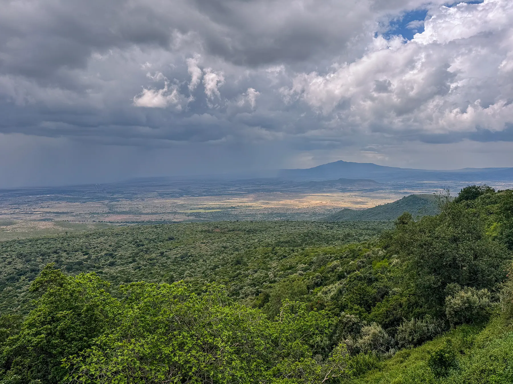 Panoramic view over the Great Rift Valley with storm clouds gathering above Lake Naivasha, Kenya