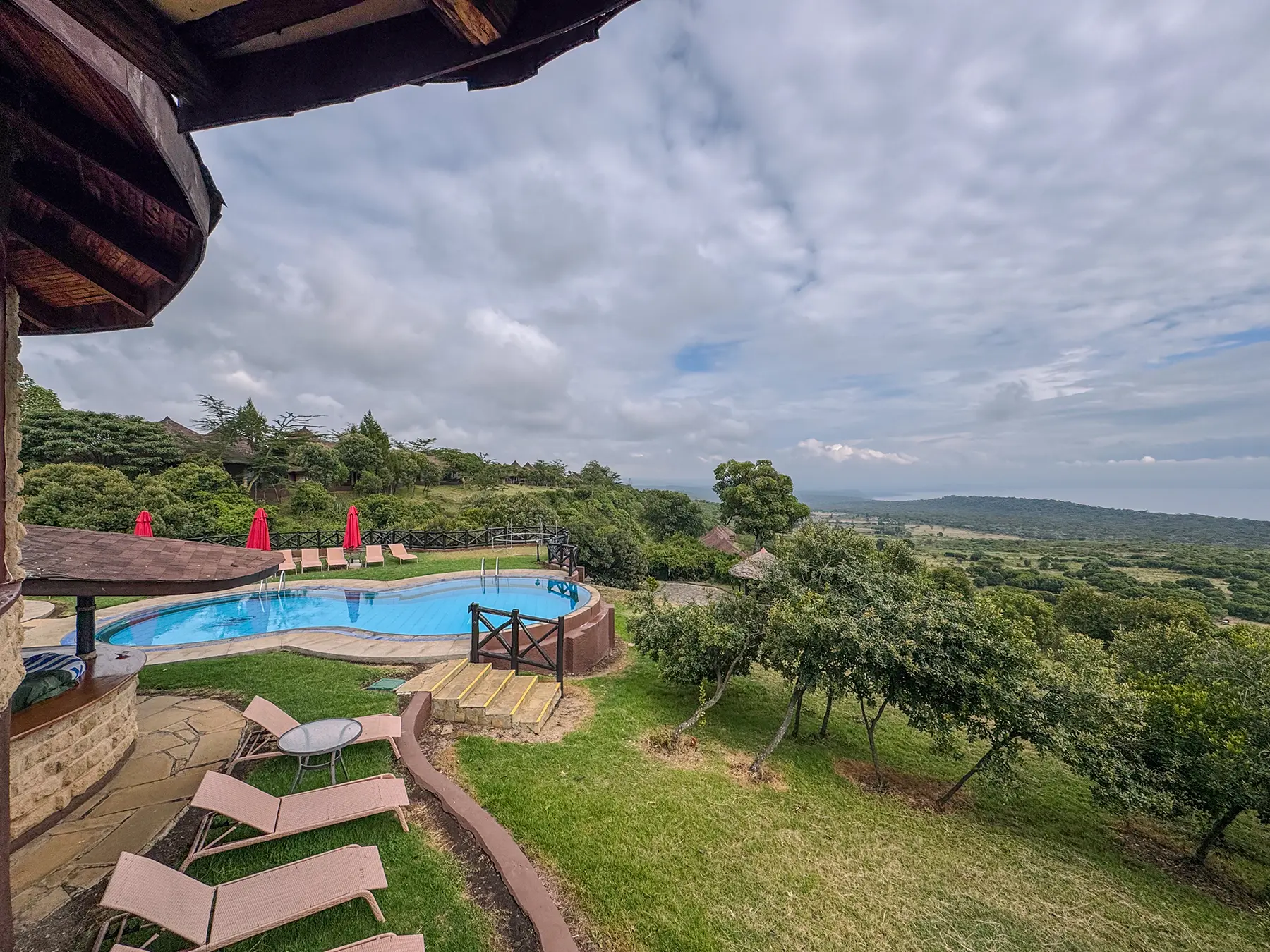 Swimming pool with sunloungers overlooking a sweeping valley at Lake Nakuru National Park, Kenya