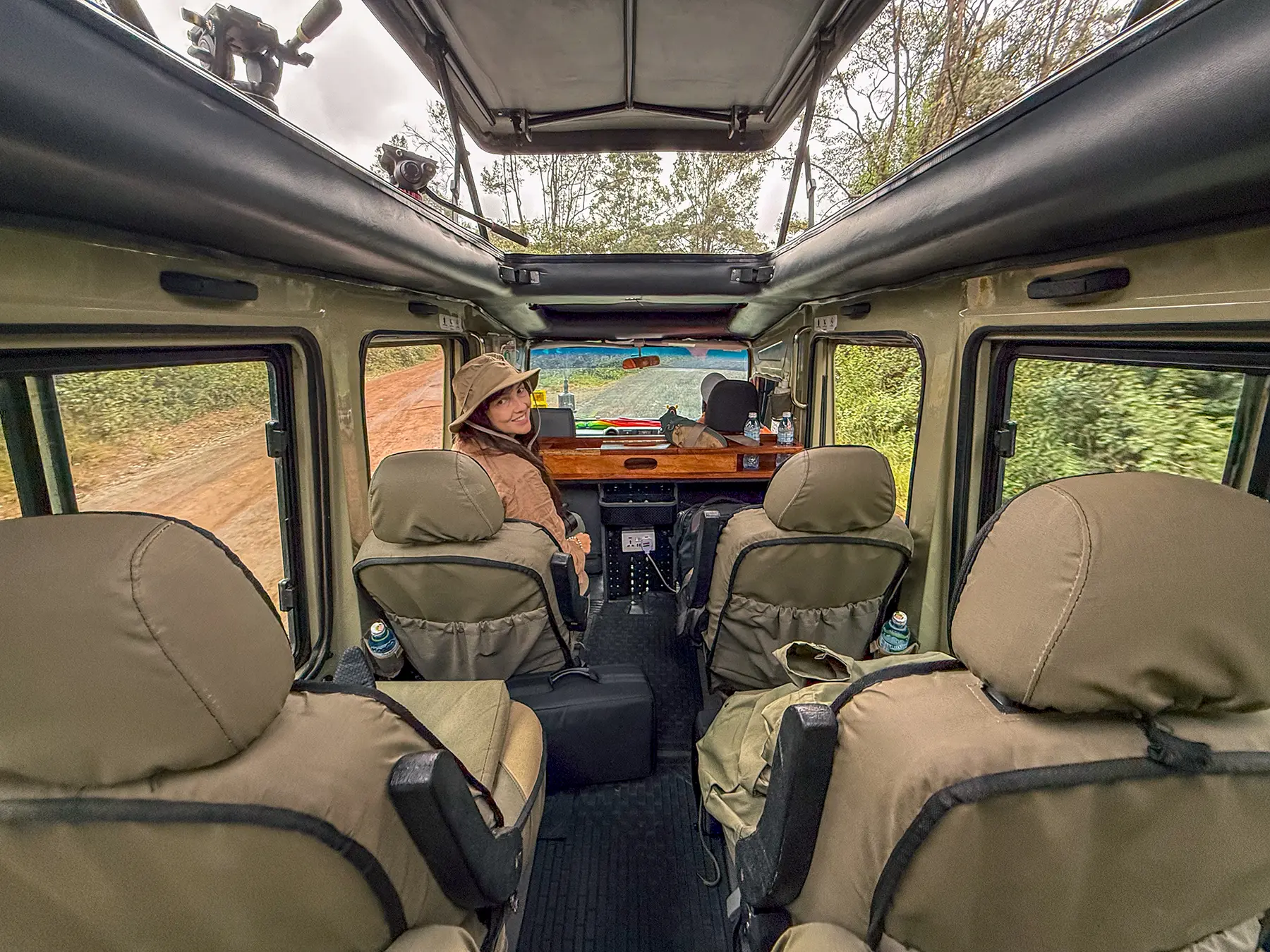Ella McKendrick seated inside a safari vehicle on a dirt road in Nairobi, Kenya